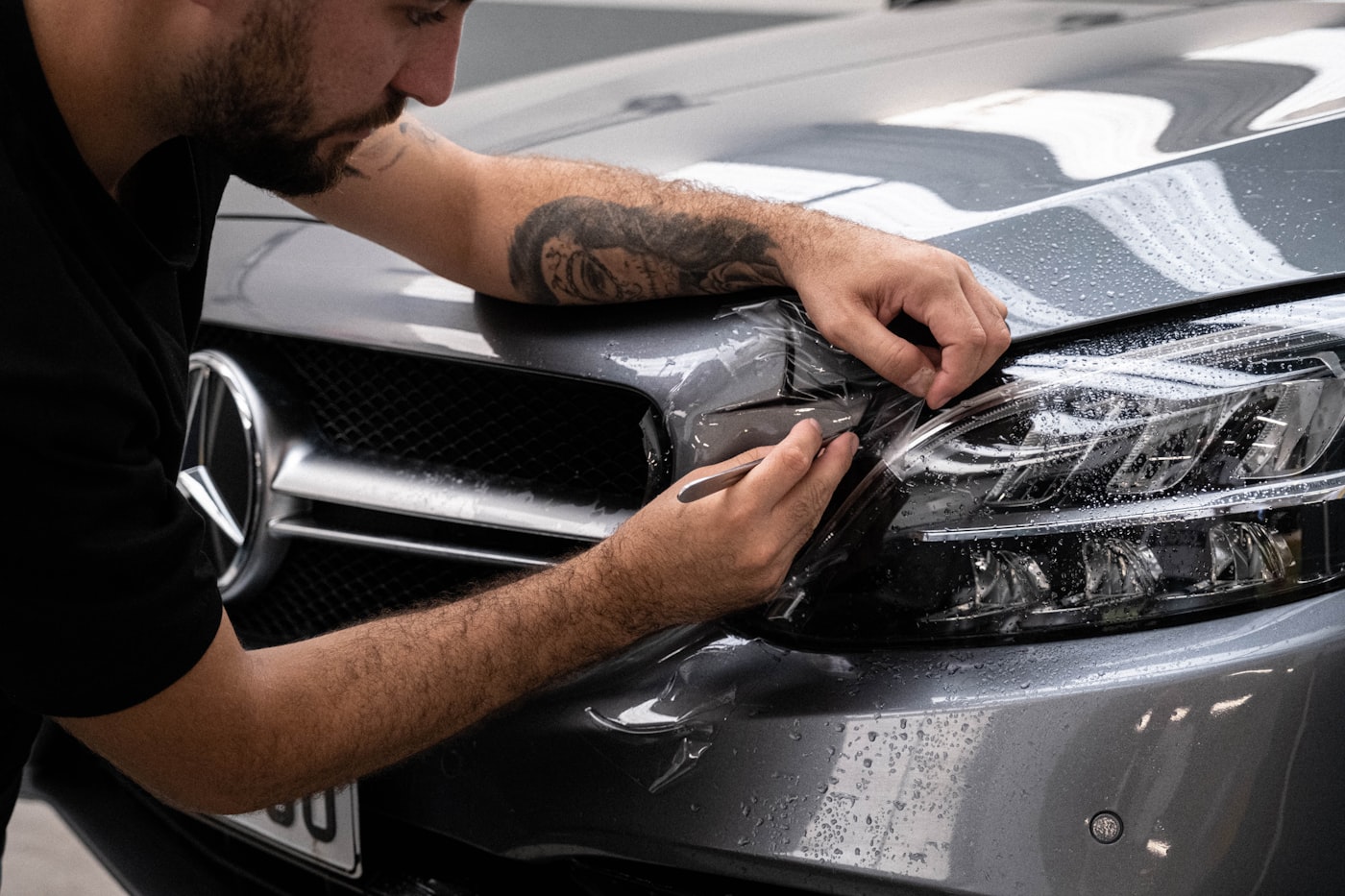Hand polishing the hood of a car